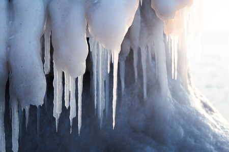 A beautiful hangign icicles of salt water on the coast of Baltic sea. Ice in the beach at winter....