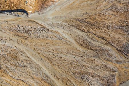 Beautiful sand patterns on the shore of baltic sea. Abstract, colorful background of sand on the...