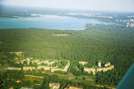 A beautiful aero landscape of Riga and area looking out of a small plane window. Riga, Latvia, Europe in summer. Authentic flying experience in a sunny, hazy day. Aero landscapeの写真素材