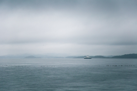 A dramatic, overcast scenery on the coeast of fjord during a ferry ride in Norway near Bergen. Moody...