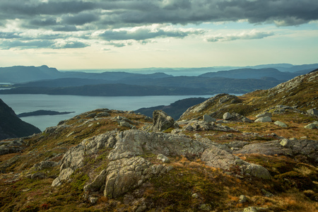 A beautiful autumn landscape in Folgefonna National Park in Norway during a hike in windy, rainy weather. Mountains in Scandinavia. Autumn scenery in wilderness.の写真素材