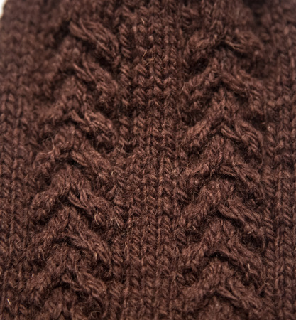 A beautiful closeup of a warm knitted pattern. Natural sheep wool yarn. Handcraft in bright colors.の写真素材