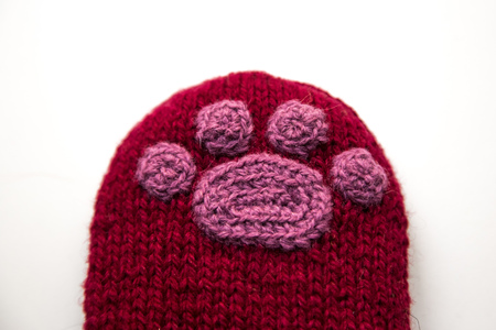 A beautiful closeup od a knitted wool socks with a crocheted animal paw pattern.