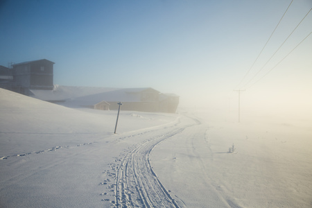 A beautiful, misty morning in the Norwegian hills in winter. White, hazy landscape. Near the small Norwegian town Roros.のeditorial素材