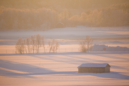 A beautiful sunset landscape of a small Norwegian ton Roros. WInter scenery with an evening sun. Warm, relaxing atmosphere.のeditorial素材