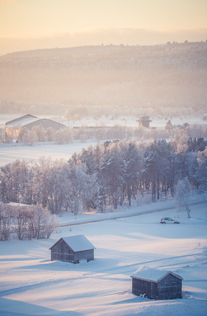 A beautiful sunset landscape of a small Norwegian ton Roros. WInter scenery with an evening sun. Warm, relaxing atmosphere.のeditorial素材