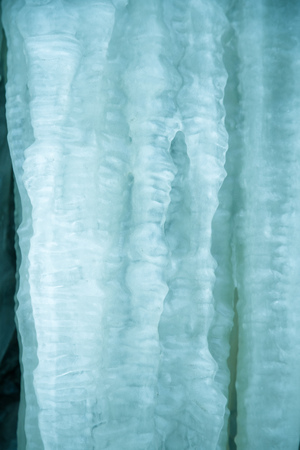 Beautiful frozen icicles on the roadside. Norwegian winter scenery. Beautiful ice structures.の写真素材