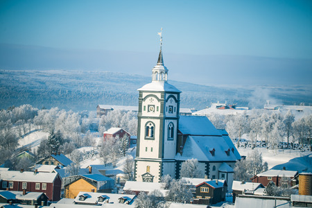 An iconic Roros church in a morning light. Beautiful winter landscape of a small Norwegian town in morning. Scandinavian scenery.のeditorial素材