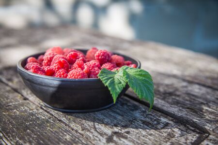 Beautiful, freshly picked garden raspberries in the summer. Summer berries, natural food, healthy dessert.の写真素材