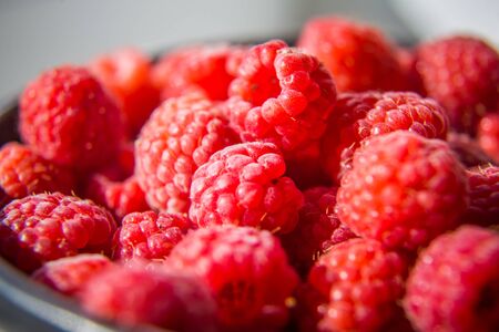 Beautiful, freshly picked garden raspberries in the summer. Summer berries, natural food, healthy...
