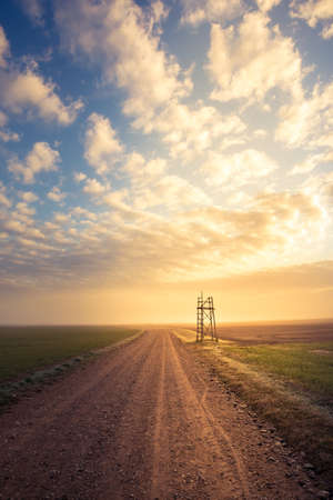 A beautiful spring landscape with a gravel road. Springtime scenery of an old road in Northern Europe.の写真素材