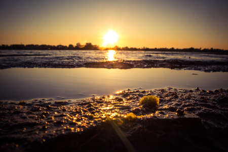 A beautiful sunset over the river in Riga, Latvia. Summer evening at the river.の写真素材