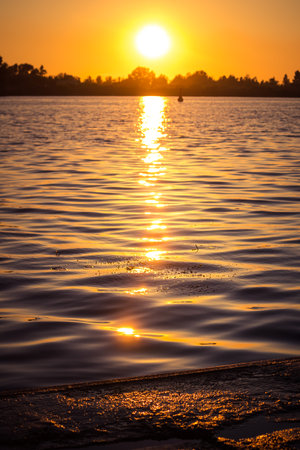 A beautiful sunset over the river in Riga, Latvia. Summer evening at the river.の写真素材