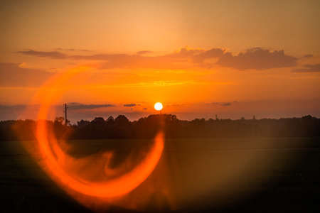 An artistic landscape wit a bright sunlight flare. Summertime scenery of Northern Europe.の写真素材