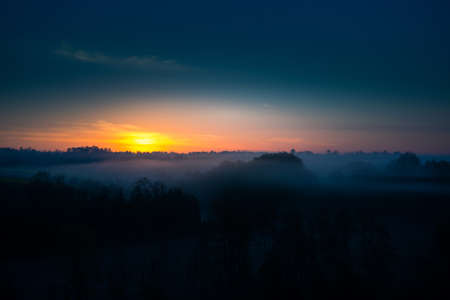 A misty sunrise landscape over the small river valley. Summertime scenery of Northern Europe.の写真素材