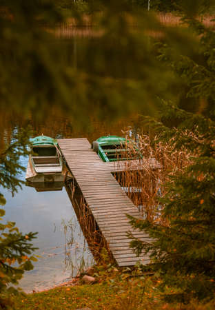 A beautiful autumn scenery at the forest lake with reflections. Fall scenery of Northern Europe.の写真素材