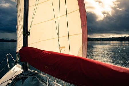 A view from a sailing boat cruising the Norway fjords. Sailing vessel in the fjord.の写真素材