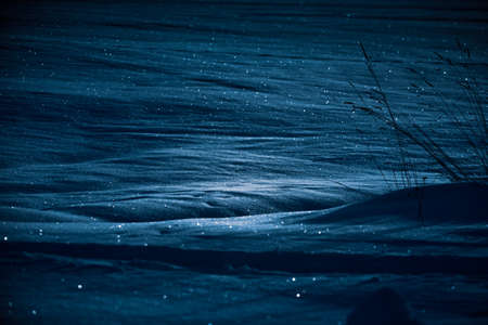 Dark winter scenery in early morning. Snowy landscape during twilight in Northern Europe.