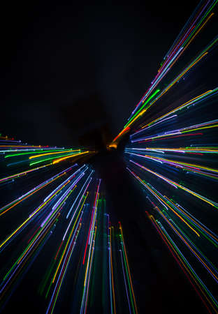 An abstract light painting with human silhouette in the middle. Led lights, christmas decorations.の写真素材