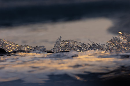 Gilded Winter: Translucent Ice Awakens in Golden Sunrise in Northern Europe