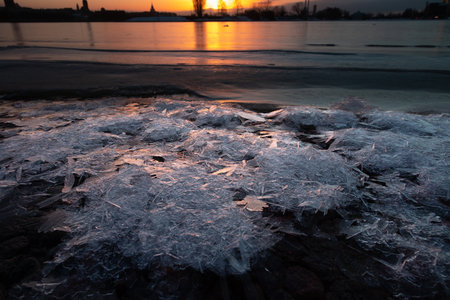 A beautiful winter sunrise landscape in Latvia capital Riga with frozen river Daugava. Colorful...