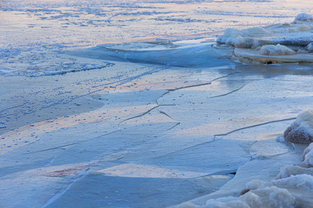 A beautiful cracked ice patterns on the frozen lake surface during winter in Latva. Cold scenery of Northern Europe.の写真素材