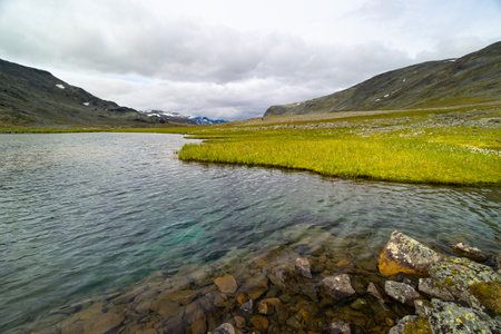 A beautiful small mountain lake in Sarek National Park, Sweden during august. Summer landscape of...