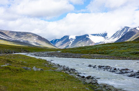 A beautiful summer landscape of mountain river in Sarek National Park, Sweden. Nordic wilderness...