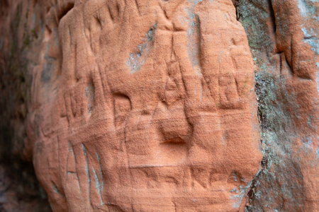 A beautiful sandstone cliff wall with engraved markings. Springtime scenery of Gauja National Park, Latvia.の写真素材