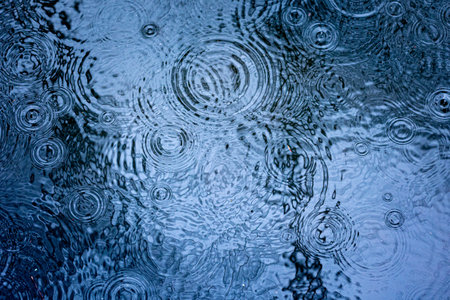A beautiful, abstract rain falling in the river. Natural springtime scenery of Northern Europe.