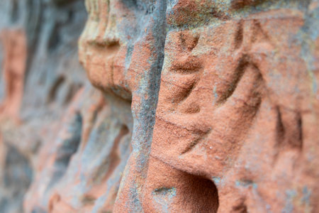 A beautiful sandstone cliff wall with engraved markings. Springtime scenery of Gauja National Park, Latvia.の写真素材
