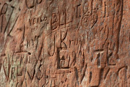 A beautiful sandstone cliff wall with engraved markings. Springtime scenery of Gauja National Park, Latvia.の写真素材