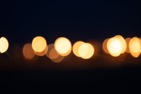 Abstract, blurry bokeh picture of a fire festival at the beach of Baltic Sea. Artistic, colorful scene.の写真素材