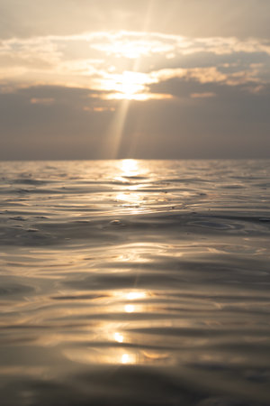 A very calm Baltic sea water surface with reflections of the sun. Beautiful summer scenery of Northern Europe.の写真素材