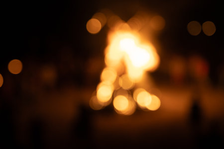 Abstract, blurry bokeh picture of a fire festival at the beach of Baltic Sea. Artistic, colorful scene.の写真素材