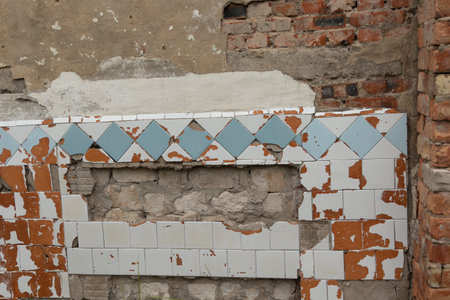 An old enamel tile wall texture. Cracked, abandoned building wall from Soviet times in Latvia, Europe.の写真素材