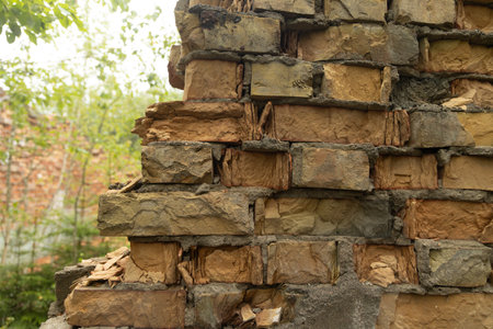 An old, collapsed building of Soviet army base in Latvie, Europe. Red brick wall of abandoned house.の写真素材