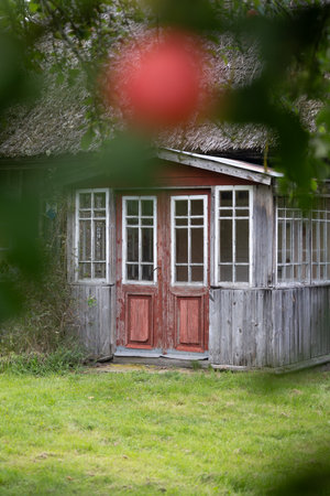 An old, wooden log building in countryside of Latvia, Europe. Wooden architecture.の写真素材