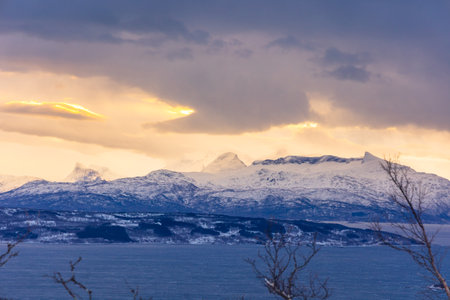 A beautiful landscape of a Norway fjord with snowy mountains during the arctic day. Arctic nature in Scandinavia during winter season.の写真素材