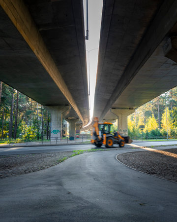 An industrial city area with bridge structures and moving cars in slow shutter speed. Cityscape of Riga, Latvia.の写真素材