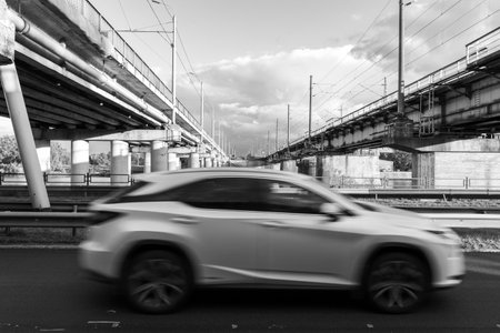 An industrial city area with bridge structures and moving cars in slow shutter speed. Cityscape of Riga, Latvia.の写真素材