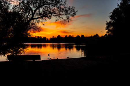 Beautiful autumn sunset at the lake with colorful skies. Evening scenery.の写真素材