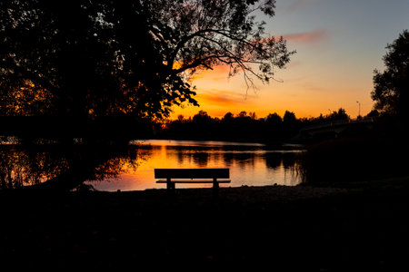 Beautiful autumn sunet at the lake with colorful skies. Evening scenery of Riga, Latvia.の写真素材