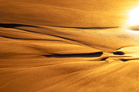 Beautiful sand patterns at the beach of Baltic Sea. Sunny summer evening.の写真素材