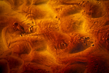 Beautiful sand and water patterns on a sunny beach.の写真素材