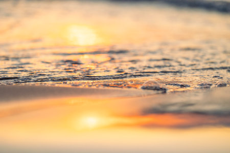 An abstract, minimalist picture of a sea waves during sunset. Shallow depth of field, bokeh, close...