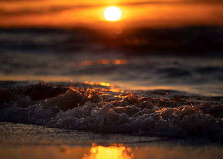 An abstract, minimalist picture of a sea waves during sunset. Shallow depth of field, bokeh, close...