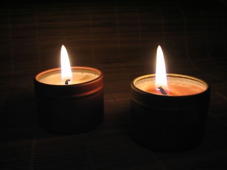Close up of a burning candle in the nightの写真素材