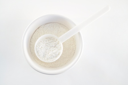 Flour - Dried ingredients in measuring spoons isolated on white の写真素材