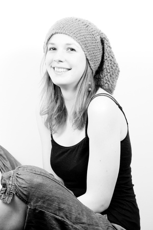 portrait of an attractive beautiful blond woman laughing with a hatの写真素材